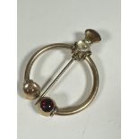 A late 19thc / early 20thc gilt metal Penanular style plain brooch with thistle bi-coloured glass on