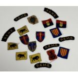 A collection of British Army cloth Divisional badges and shoulder tithes.