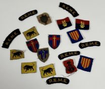 A collection of British Army cloth Divisional badges and shoulder tithes.