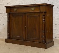 An Edwardian walnut side cabinet, fitted with a drawer above two panelled cupboards enclosing a