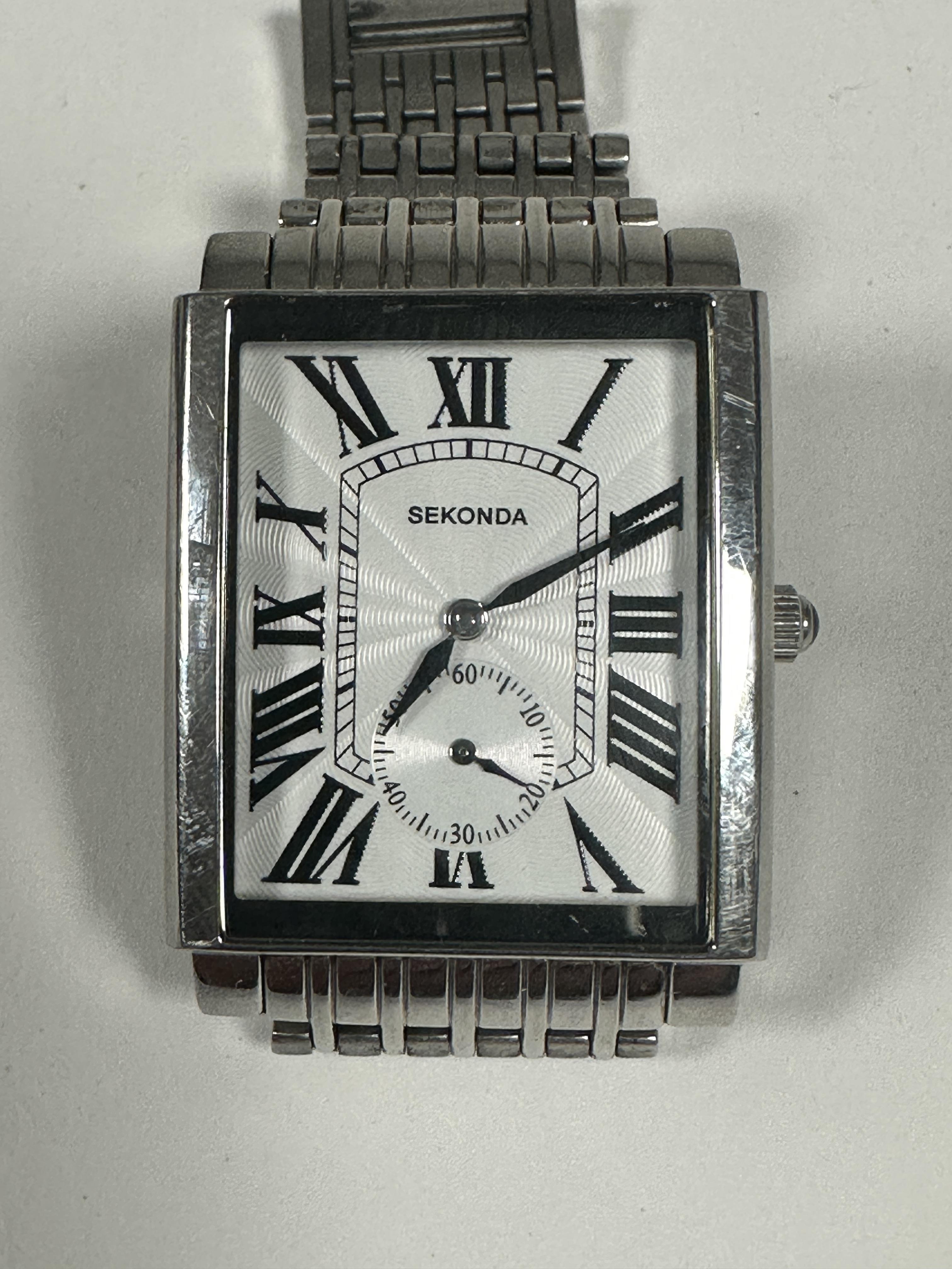 A Gents Sekonda quartz stainless steel large tank style wrist watch with white enamel dial and Roman