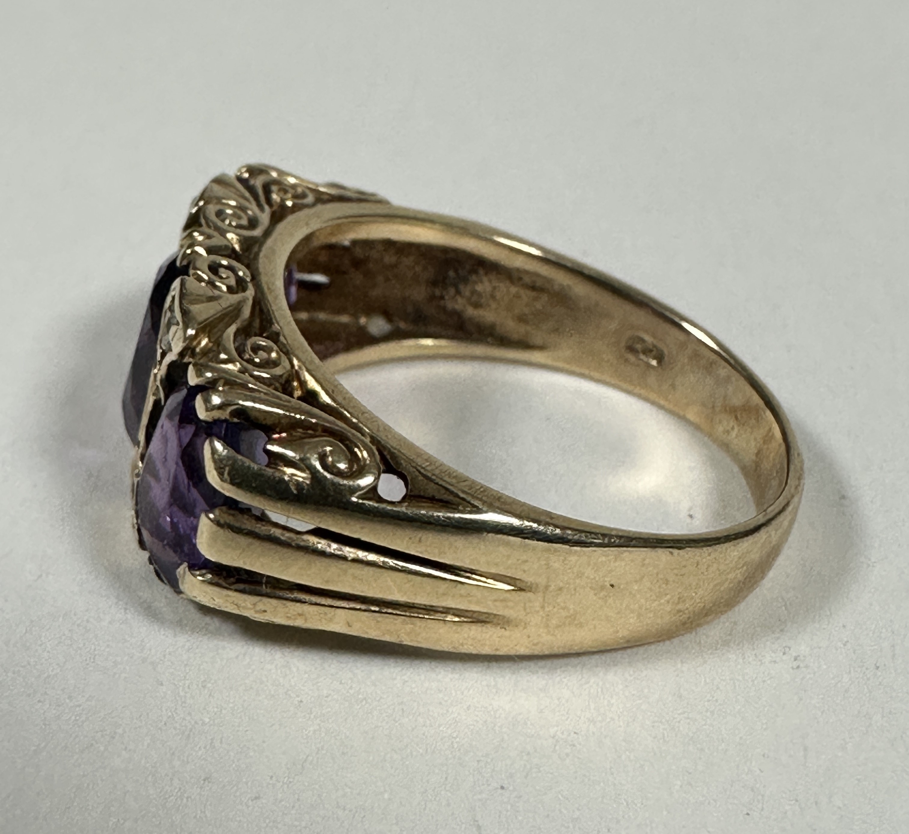 A 9ct Gold graduated three stone Amethyst and Diamond ring, the oval centre stone set with four - Image 2 of 3