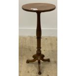 A Victorian oak tripod table, the circular top over a ring turned column and triple splay supports