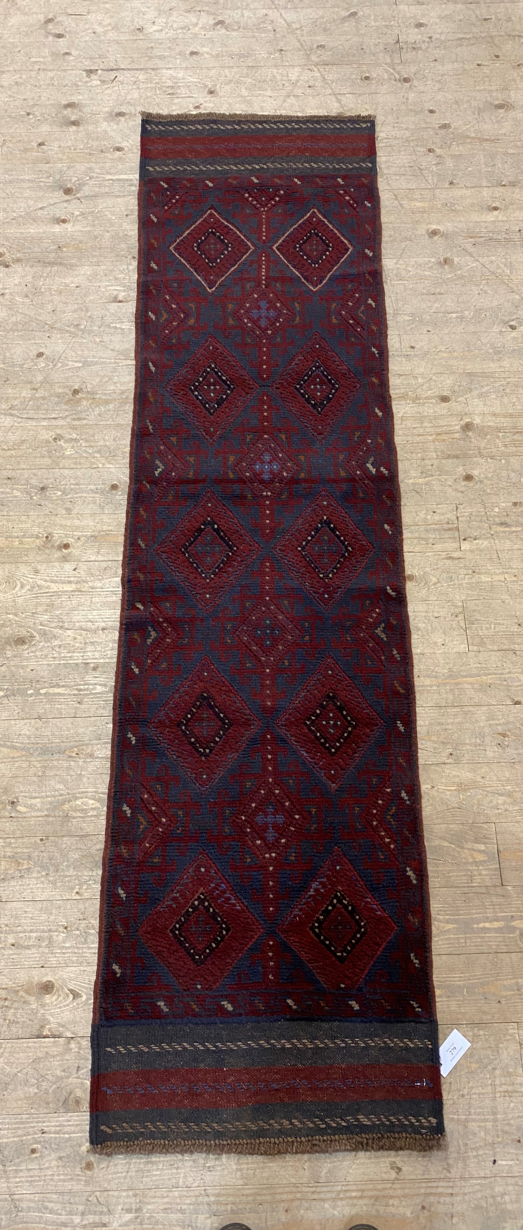 A Meshwani runner rug, decorated with eight lozenges 235cm x 59cm