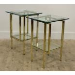 A pair of Hollywood Regency style end tables, plate glass top raised on gilt brass square section