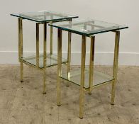 A pair of Hollywood Regency style end tables, plate glass top raised on gilt brass square section