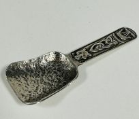 A Scottish Celtic Art Industries Iona Sterling Silver caddy spoon with cast Celtic knot, boat and