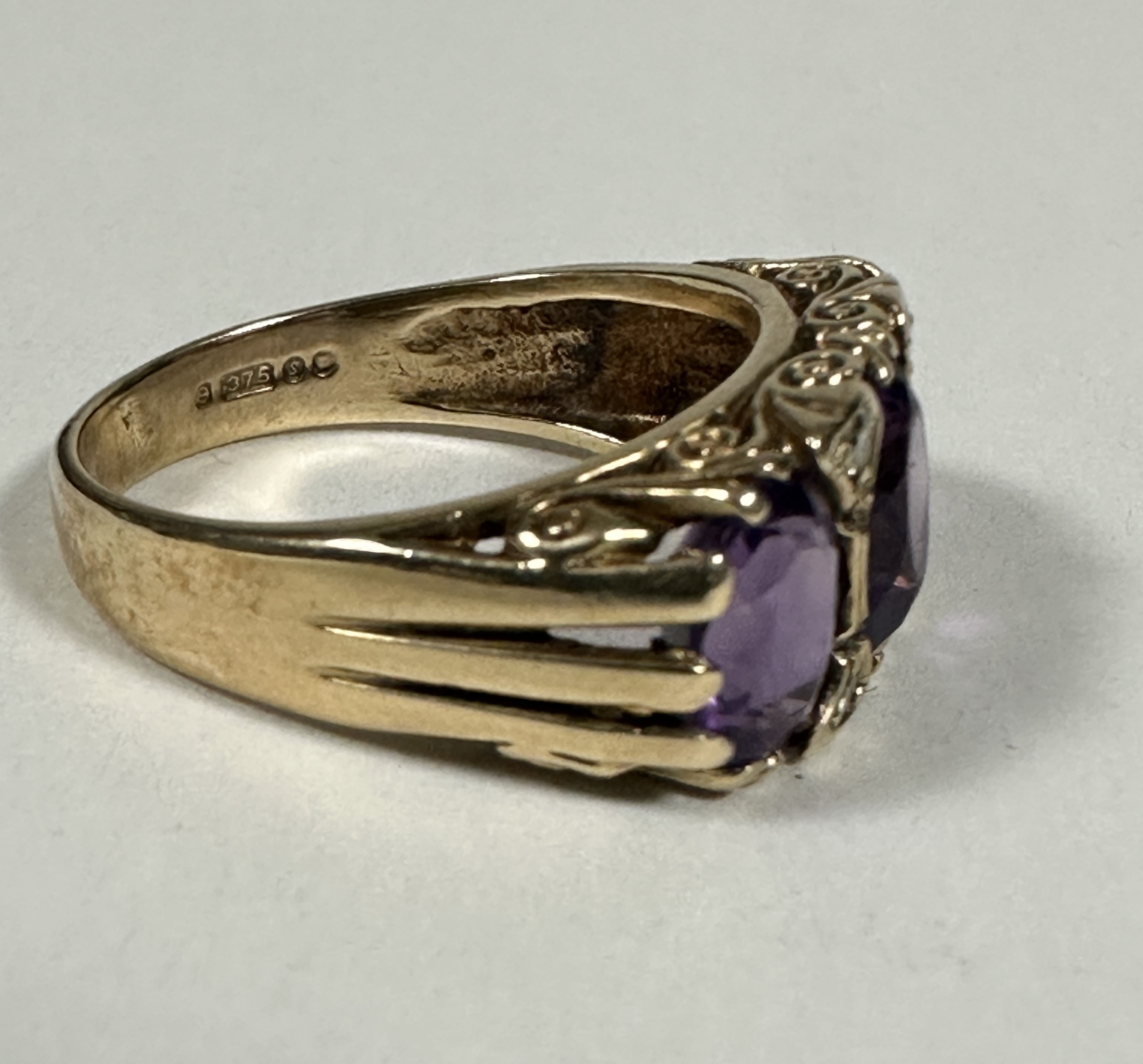 A 9ct Gold graduated three stone Amethyst and Diamond ring, the oval centre stone set with four - Image 3 of 3