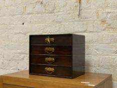 An Edwardian stained and lacquered mahogany table top chest fitted with four drawers having gilt