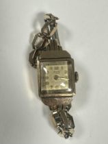 A 9ct gold Benson of London lady's Art Deco wrist watch with square gilt dial and Arabic numerals on