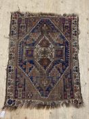 An Antique Caucasian hand knotted rug with lozenge medallion to centre