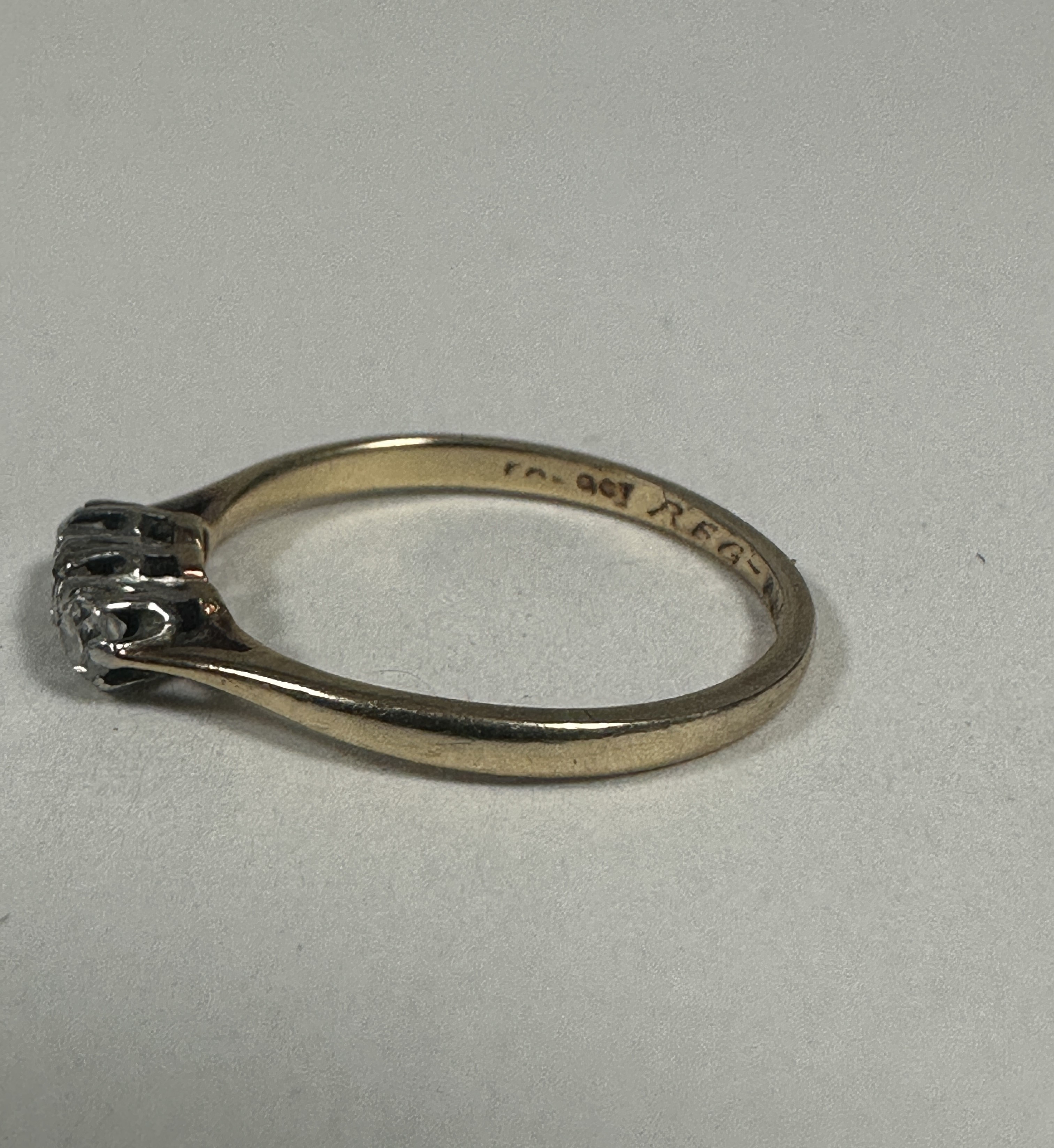 A 9ct gold three stone diamond ring set in platinum claw setting, K. 1.06g - Image 2 of 3