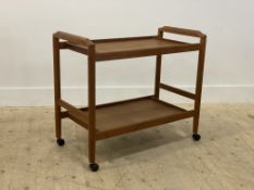 A mid century teak drinks trolley, the two tiers on turned supports moving on castors H66cm,