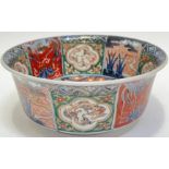 A Japanese polychrome enamelled porcelain bowl decorated with panels depicting dragons and ho-ho