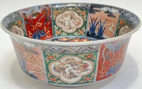 A Japanese polychrome enamelled porcelain bowl decorated with panels depicting dragons and ho-ho
