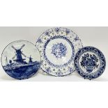 Three blue and white dishes comprising a large Portugese Delft-style pierced-edge charger (marked