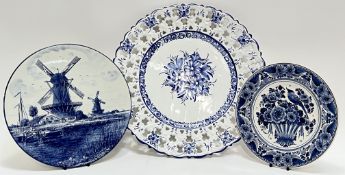 Three blue and white dishes comprising a large Portugese Delft-style pierced-edge charger (marked