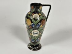 A Arts and Crafts pottery baluster single handled vase decorated in middle eastern style with