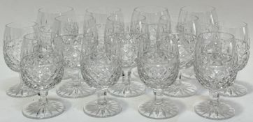 A group of thistle-form cut crystal drinking glasses comprising seven brandy glasses (h- 11.5cm),