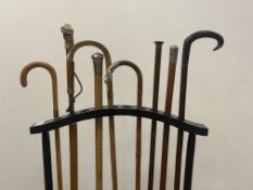 A good collection of seven walking sticks, five with silver mounts, one with horn handle, together