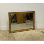 A gilt composition framed wall hanging mirror in the Rococo taste 104cm x 74cm