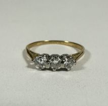A yellow metal and platinum three stone Diamond ring, the brilliant cut stones approximately o.