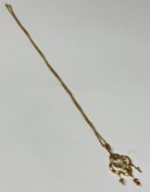 An Edwardian 9ct gold open work pendant of oval shaped design set Peridot, seed pearl flowers and