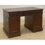 A Victorian mahogany twin pedestal desk, the top inset with tooled oxblood leather writing