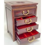 A miniature Chinese carved hardwood chest of drawers/jewellery box with shou symbol to top and