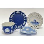 A Wedgwood Jasperware cup and saucer with neoclassical style sprigged decoration (marked verso) (
