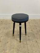 A mid century stool, circa 1970, the vinyl upholstered seat raised on three turned and tapered