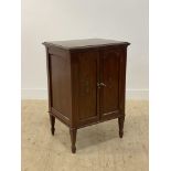 An Edwardian mahogany sheet music cabinet, the twin arch panelled doors with simulated inlay
