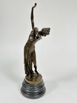 A cast bronze standing figure after the Roman style of a draped lady with arm raised mounted on