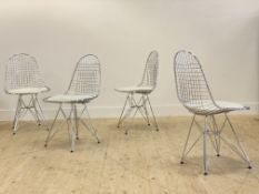 After Charles and Ray Eames, a set of four chrome plated wire dining chairs, with faux white leather