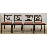 A set of four Regency style mahogany dining chair, with drop in seat pads and raised on sabre
