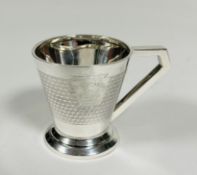 A Birmingham silver Art Deco christening cup of tapered cylindrical form with squared handle to side
