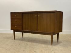 A mid century tola wood (teak) sideboard, circa 1960's, fitted with three drawers flanked by a
