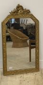 A gilt painted wall mirror, early 20th century, the floral moulded frame with doe and acanthus