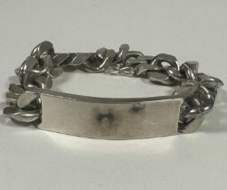 A gents heavy Sterling Silver flat kerb link identity bracelet, uninscribed,(D x 7cm). 94.2g