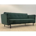 A Contemporary green crushed velvet upholstered three seat sofa bed, standing on black aluminium
