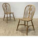 A set of three light ash Windsor chairs, with hoop, spindle and splat back over saddle seat,