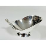 A Mappin & Webb Sheffield silver dish with scalloped out swept form and triple wave scroll handle to