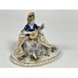 A Capo di Monte porcelain figure " The lute Player " decorated with polychrome enamels, losses to