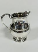 A Edwardian London silver cream jug by Goldsmiths & Silversmiths Company, of baluster form with C