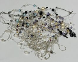 A collection of four Chinese cultured pearl multi stand necklaces, a paste pearl and French jet bead