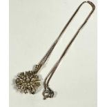 An Edwardian yellow metal sunburst style pendant set seed pearls with loop to top and later pin