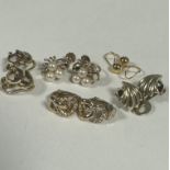 A group of four 9ct gold clip and screw on earrings including cultures pearl ribbon earrings, a pair