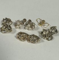 A group of four 9ct gold clip and screw on earrings including cultures pearl ribbon earrings, a pair
