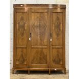 A quality 1920's figured walnut bow front triple wardrobe, each panelled door inset with burr wood