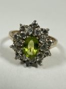 A 9ct gold oval Peridot and CZ set cluster ring, the Peridot approximately 0.75ct, P. 3.68g